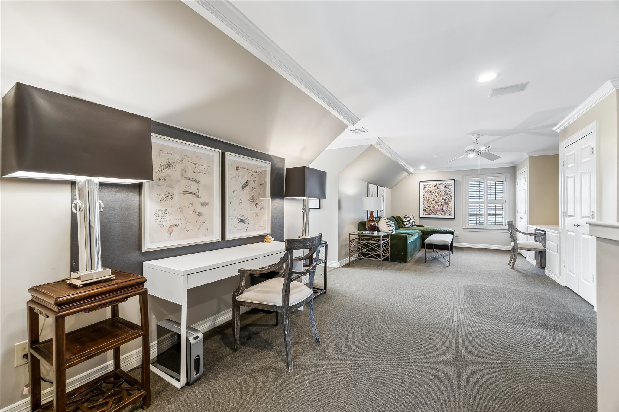 2627 Sutton Court Houston, TX 77027 - Photo 25 of 34 The versatile third-floor space with a full bath easily adapts to your needs—perfect as a home office, media room, or playroom. It features a built-in desk, a window bench with storage, and convenient walk-in attic access.