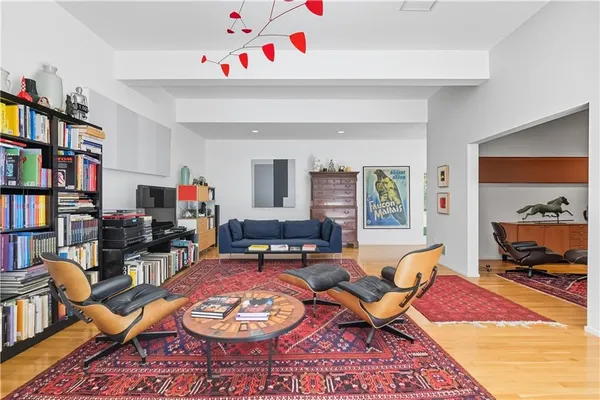 a living room with furniture and a book shelf