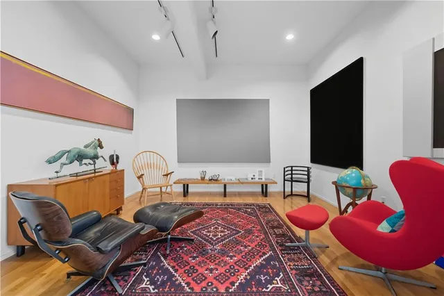 a living room with furniture rug and wooden floor