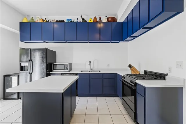 a kitchen with stainless steel appliances a cabinets and a stove top oven