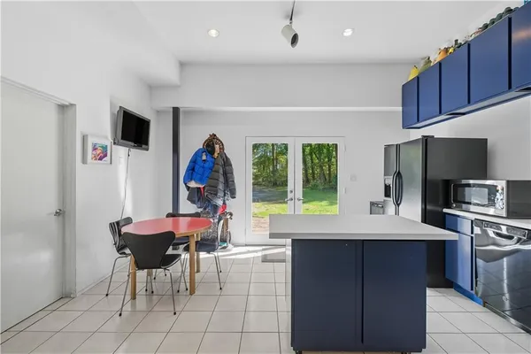 a view of a kitchen with a dining table and chairs