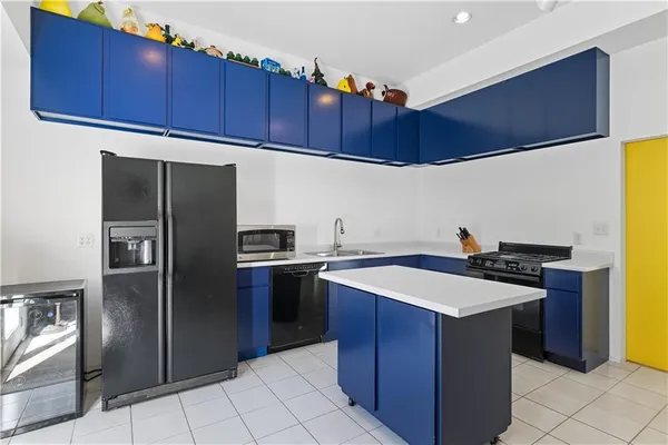 a kitchen with stainless steel appliances a stove a refrigerator and a sink