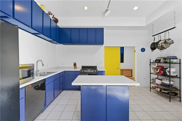 a kitchen with wooden cabinets and center island