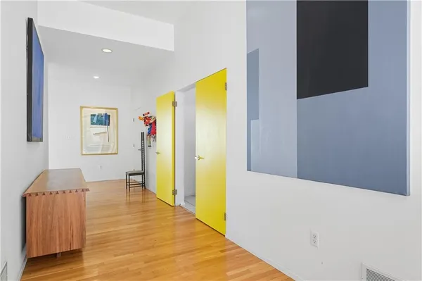 a hallway with wooden floor and furniture