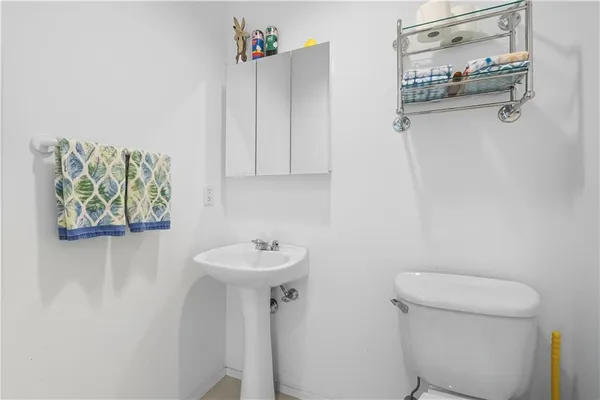 a bathroom with a sink a toilet and a mirror
