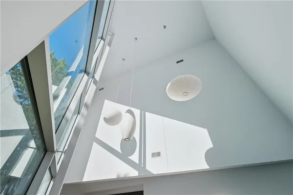 a living room with furniture and a floor to ceiling window