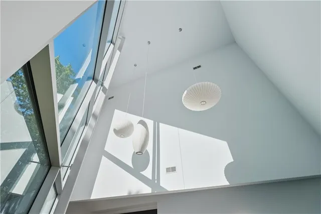 a living room with furniture and a floor to ceiling window