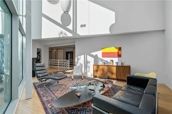 a living room with a couch and a floor to ceiling window