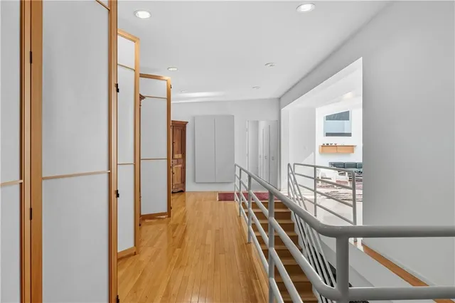 a bedroom with furniture and a large window