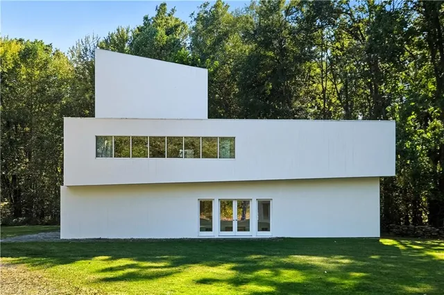 a view of a house with pool and a yard