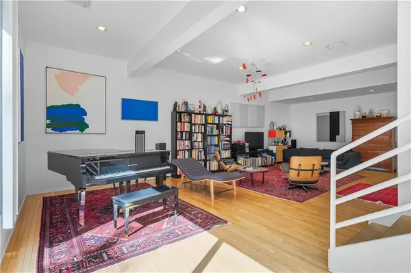 a living room with furniture gym equipment and a rug
