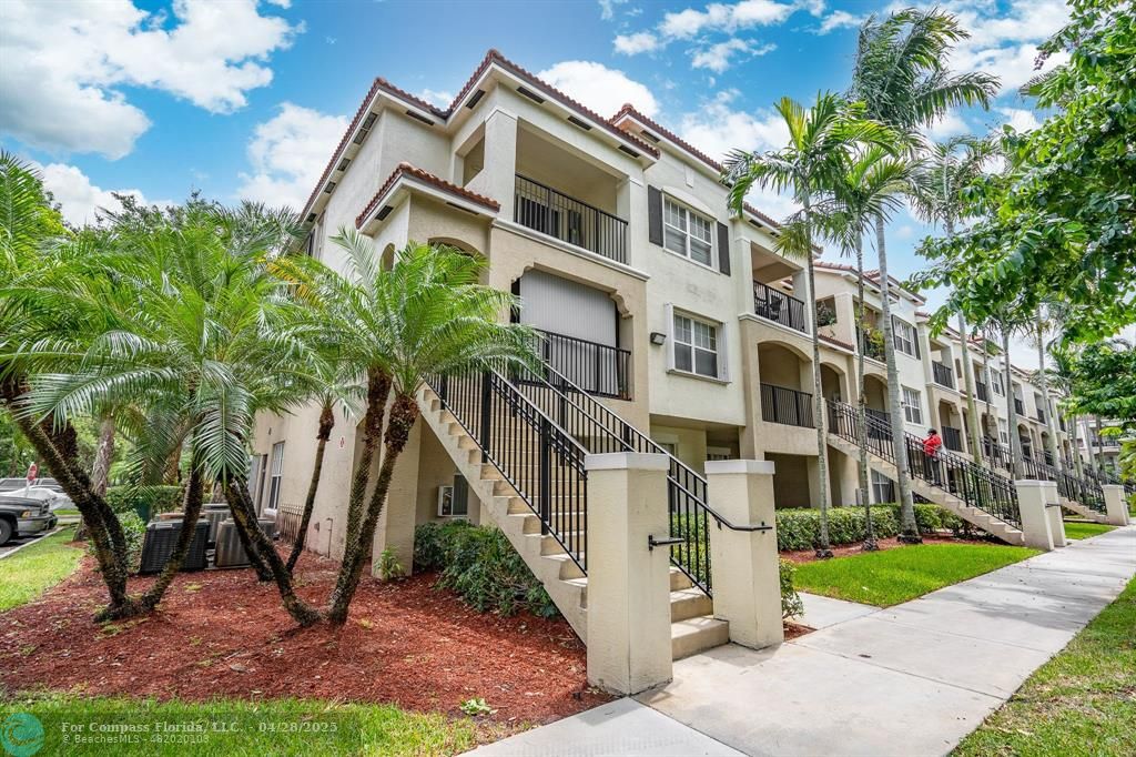 5840 West Sample Road, Unit 301 Coral Springs, FL 33067 - Photo 1 of 19 a view of a building with a yard