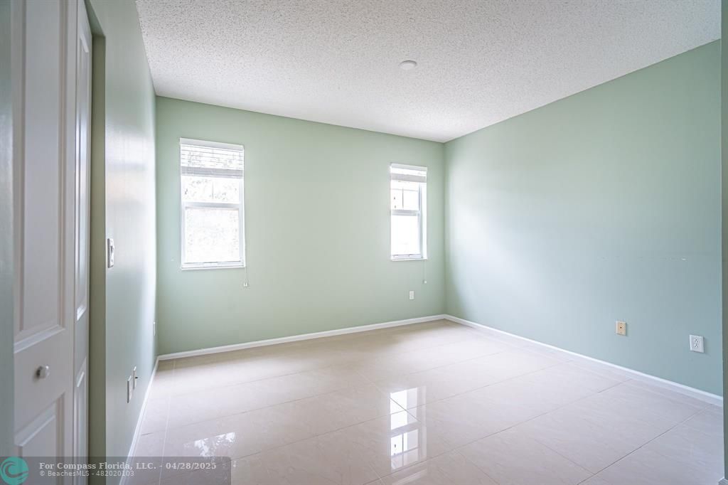 5840 West Sample Road, Unit 301 Coral Springs, FL 33067 - Photo 11 of 19 an empty room with windows