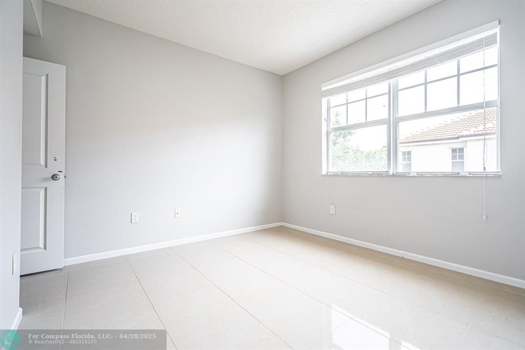 5840 West Sample Road, Unit 301 Coral Springs, FL 33067 - Photo 13 of 19 an empty room with a window