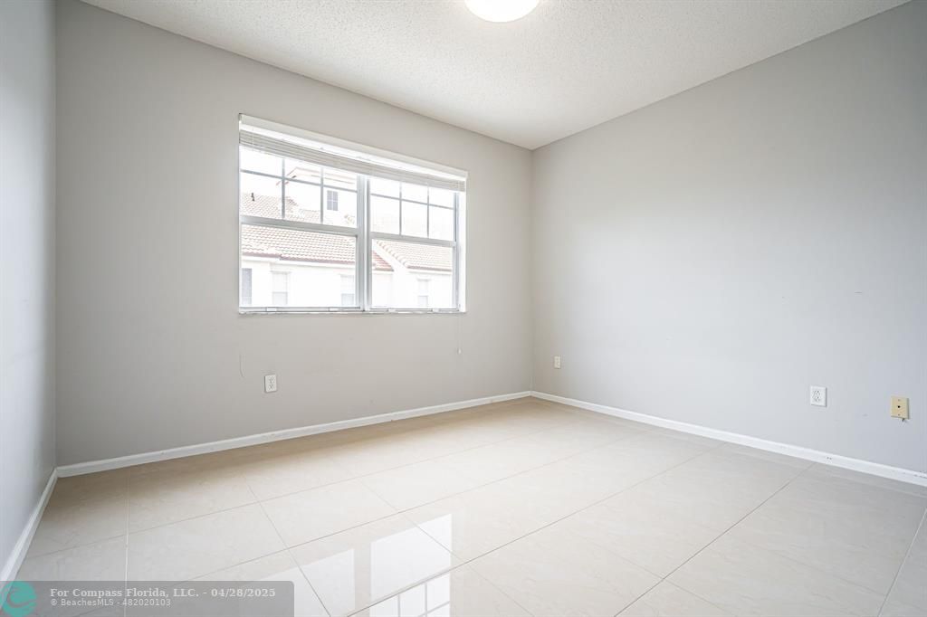 5840 West Sample Road, Unit 301 Coral Springs, FL 33067 - Photo 14 of 19 an empty room with a window