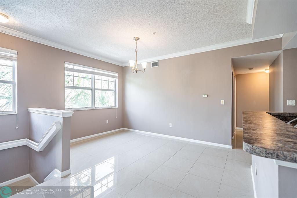 5840 West Sample Road, Unit 301 Coral Springs, FL 33067 - Photo 4 of 19 a view of livingroom with hardwood floor and hallway