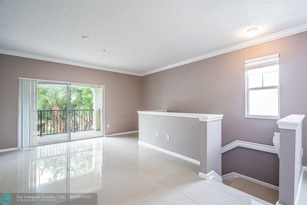 5840 West Sample Road, Unit 301 Coral Springs, FL 33067 - Photo 5 of 19 a view of an empty room with a window