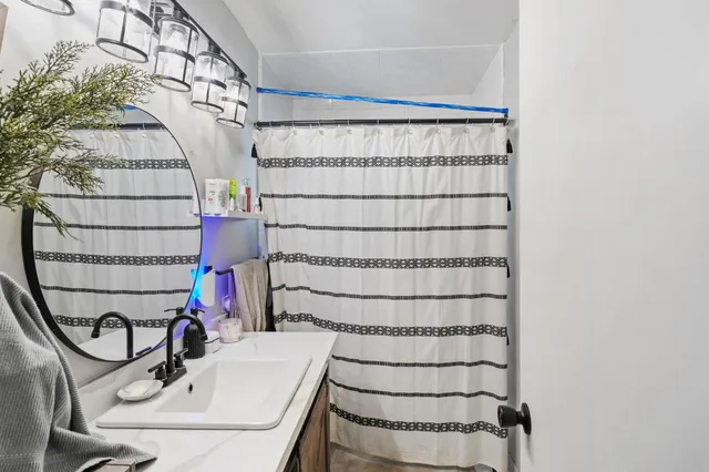 a bathroom with a sink and a mirror