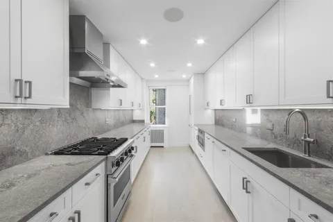 a kitchen with stainless steel appliances granite countertop a sink stove and cabinets