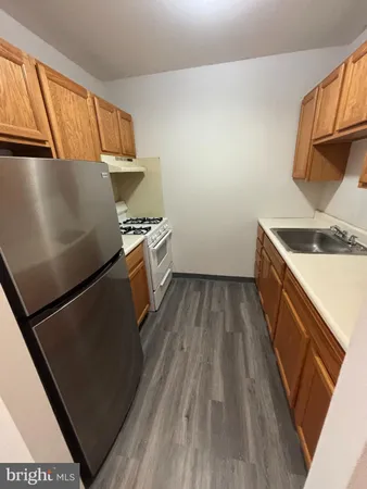 a kitchen with wooden cabinets and a stove top oven