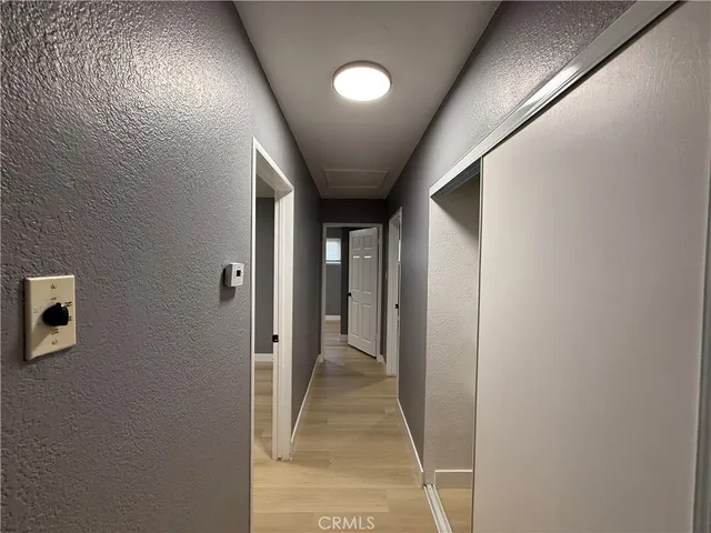 an empty room with closet and windows