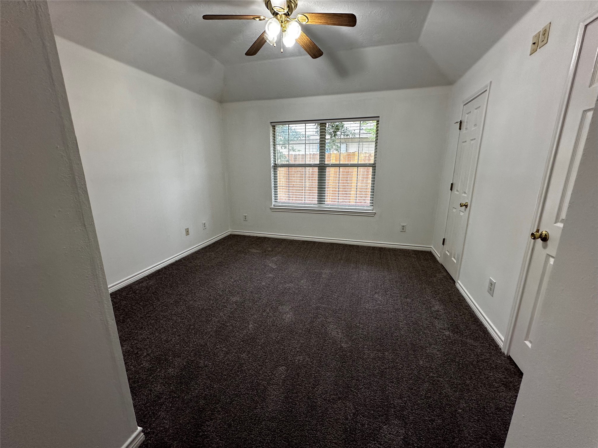 1400 Prairie Drive Bryan, TX 77802 - Photo 9 of 18 A comfortable bedroom features plush carpeting and a modern ceiling fan, offering a serene personal space.