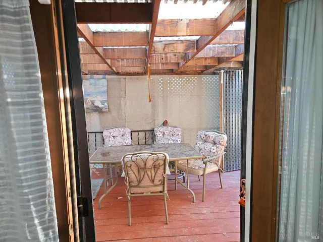a balcony view with a table and chairs