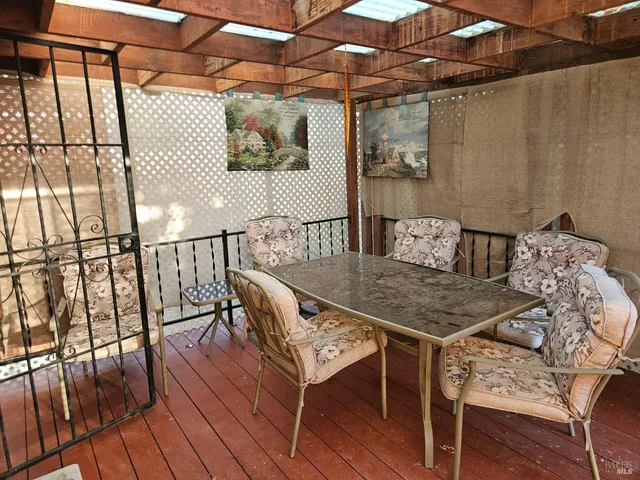a view of a balcony with furniture and wooden floor