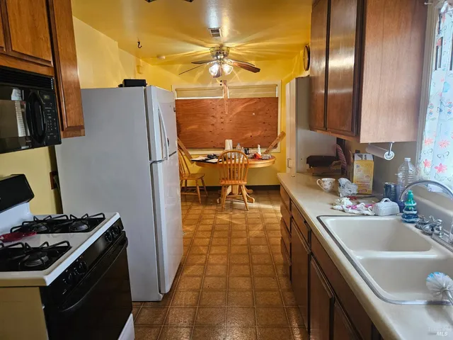 a kitchen with a sink appliances and cabinets
