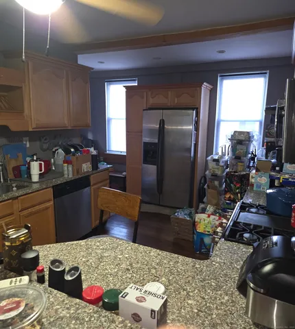 a kitchen with sink refrigerator and cabinets
