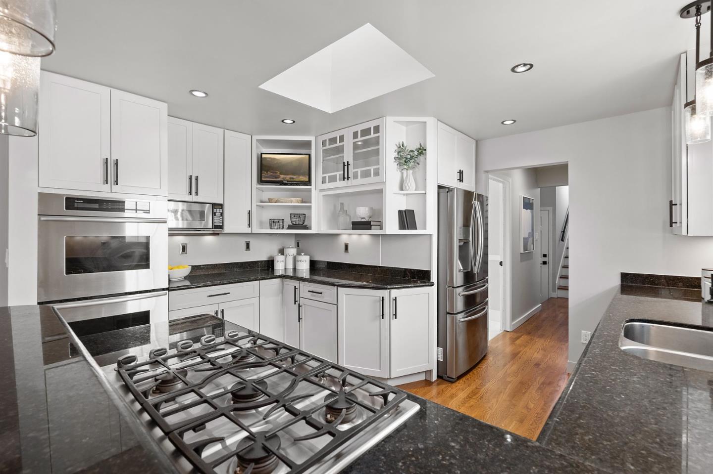 1652 Ralston Avenue Belmont, CA 94002 - Photo 11 of 45 a kitchen with stainless steel appliances kitchen island granite countertop a refrigerator oven a sink and dishwasher
