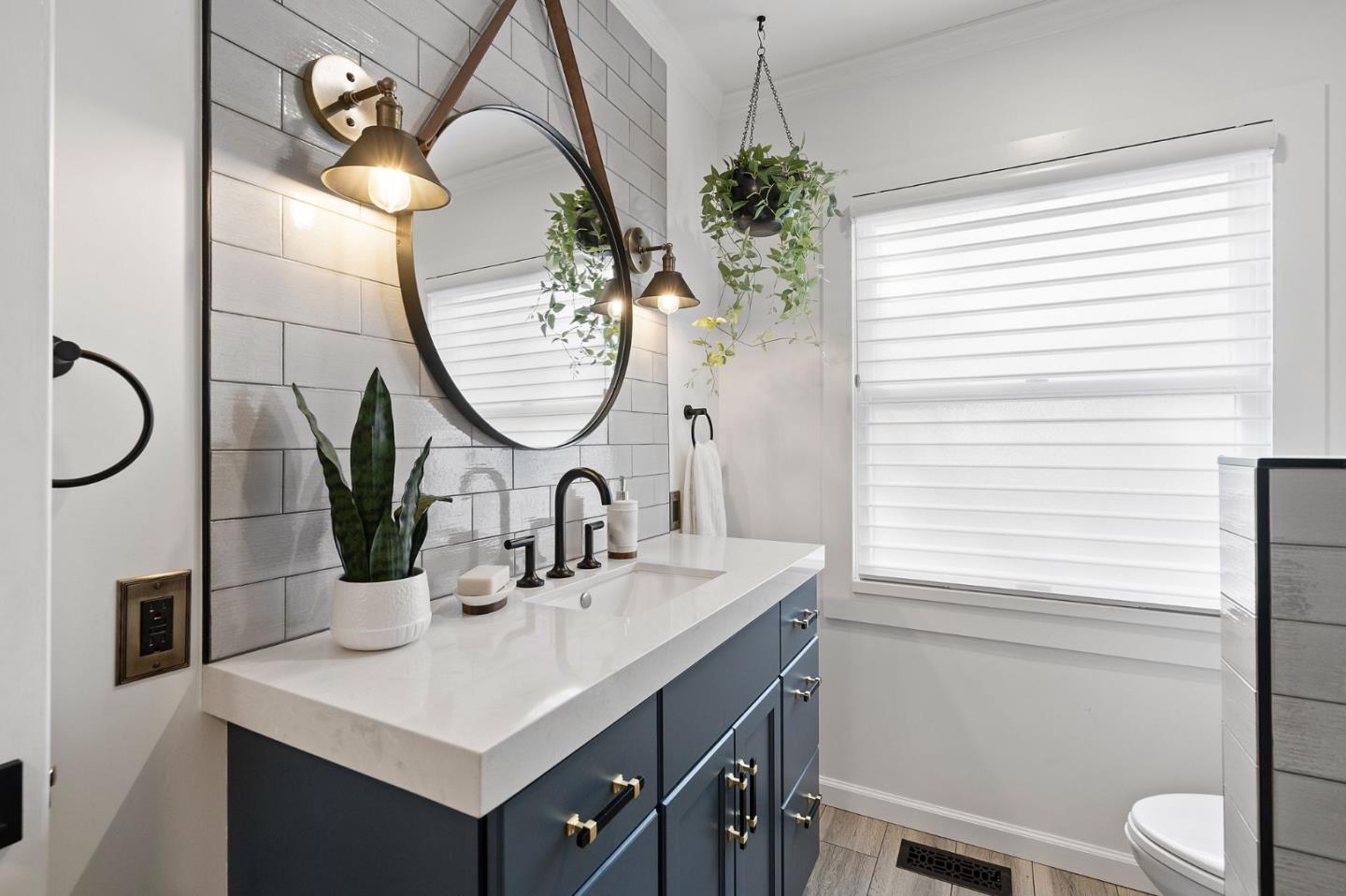 1652 Ralston Avenue Belmont, CA 94002 - Photo 20 of 45 a bathroom with a sink a toilet and a mirror