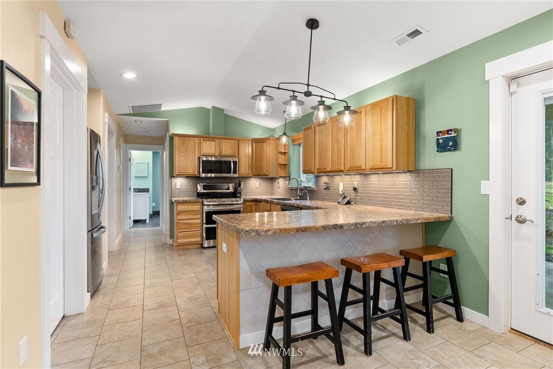 469 Brown Road East Chehalis, WA 98532 - Photo 11 of 35 a kitchen with stainless steel appliances granite countertop a sink a stove a refrigerator and island