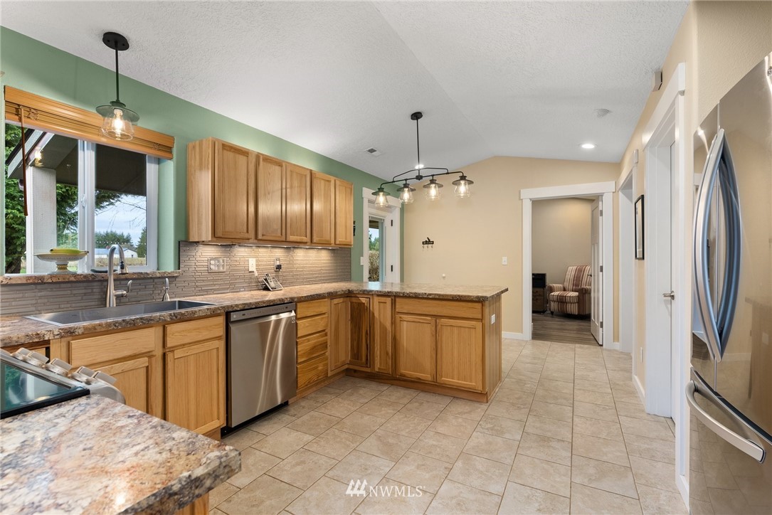 469 Brown Road East Chehalis, WA 98532 - Photo 14 of 35 a large kitchen with a large counter top space a sink stainless steel appliances and cabinets