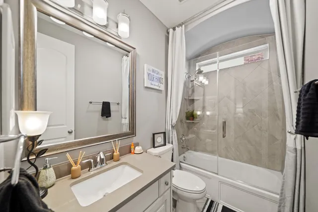 a bedroom with a bed a large window and a flat screen television