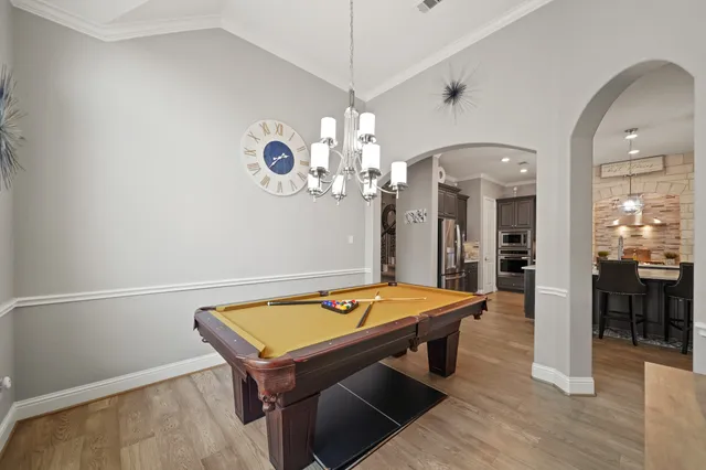 a large kitchen with a table and chairs