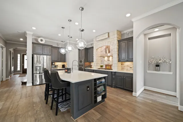 a kitchen with stainless steel appliances a stove and a sink