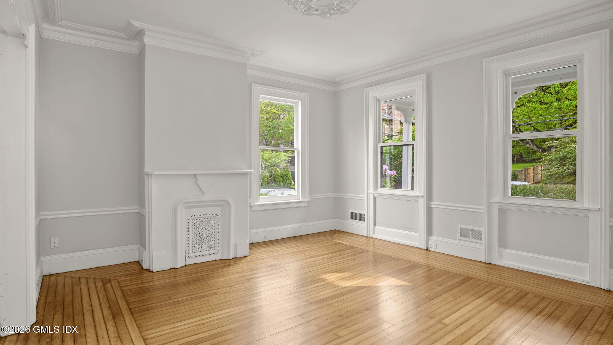 43 Church Street, Unit 1 Greenwich, CT 06830 - Photo 5 of 17 a view of an empty room with wooden floor and a window