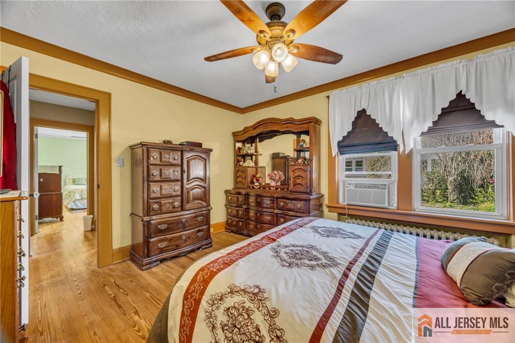 38 Simpson Avenue Edison, NJ 08817 - Photo 20 of 37 a bedroom with a bed a dresser and a large window