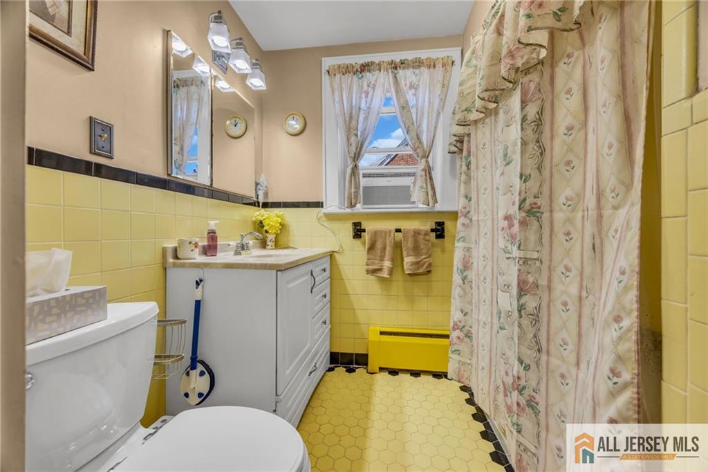 38 Simpson Avenue Edison, NJ 08817 - Photo 34 of 37 a bathroom with a sink mirror toilet and shower