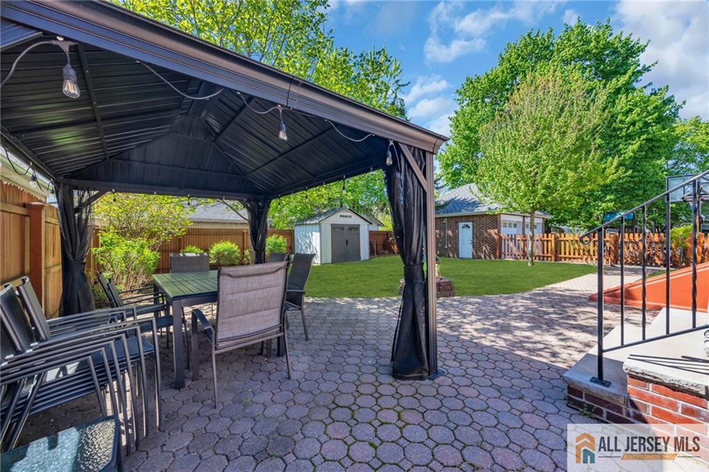 38 Simpson Avenue Edison, NJ 08817 - Photo 35 of 37 a view of a patio with a table chairs and a backyard