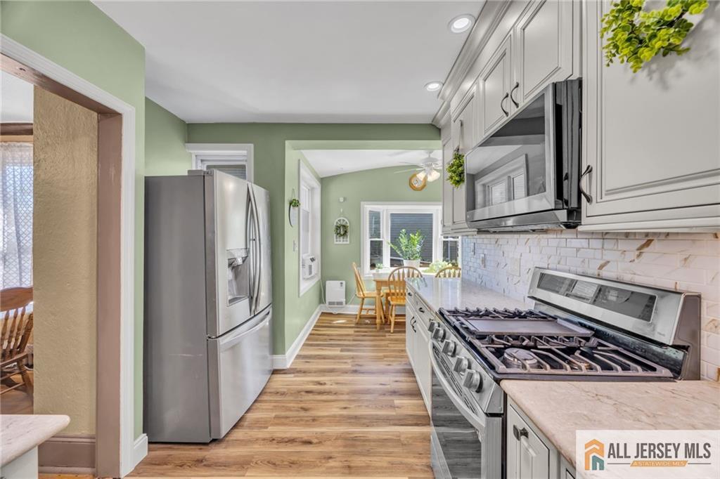 38 Simpson Avenue Edison, NJ 08817 - Photo 5 of 37 a kitchen with stainless steel appliances granite countertop a stove and a refrigerator