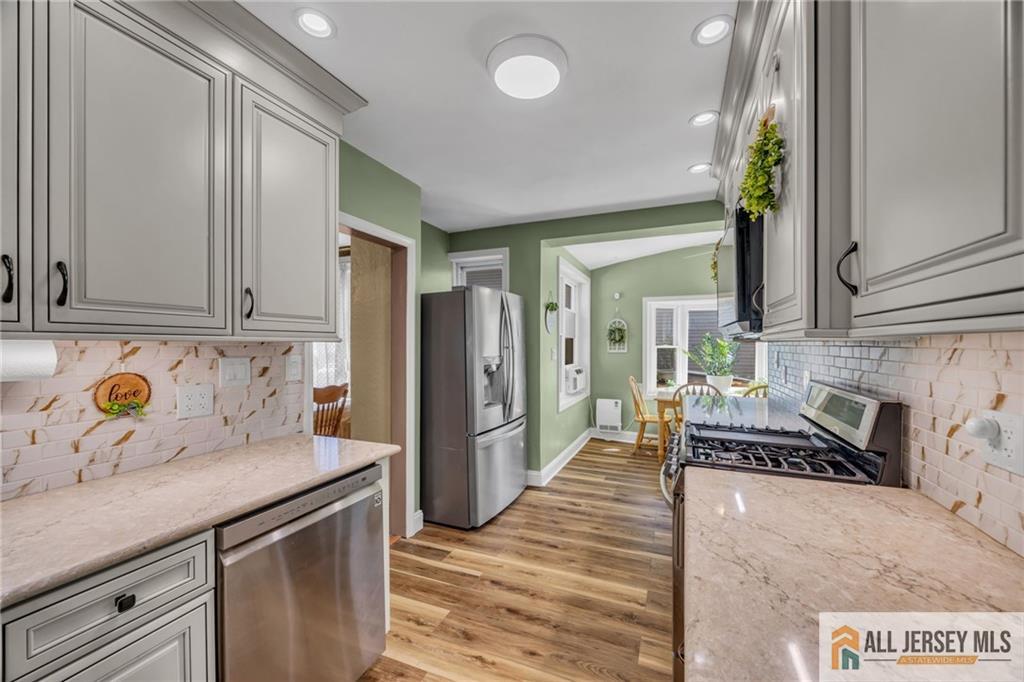 38 Simpson Avenue Edison, NJ 08817 - Photo 8 of 37 a kitchen with stainless steel appliances granite countertop a refrigerator a stove and a sink
