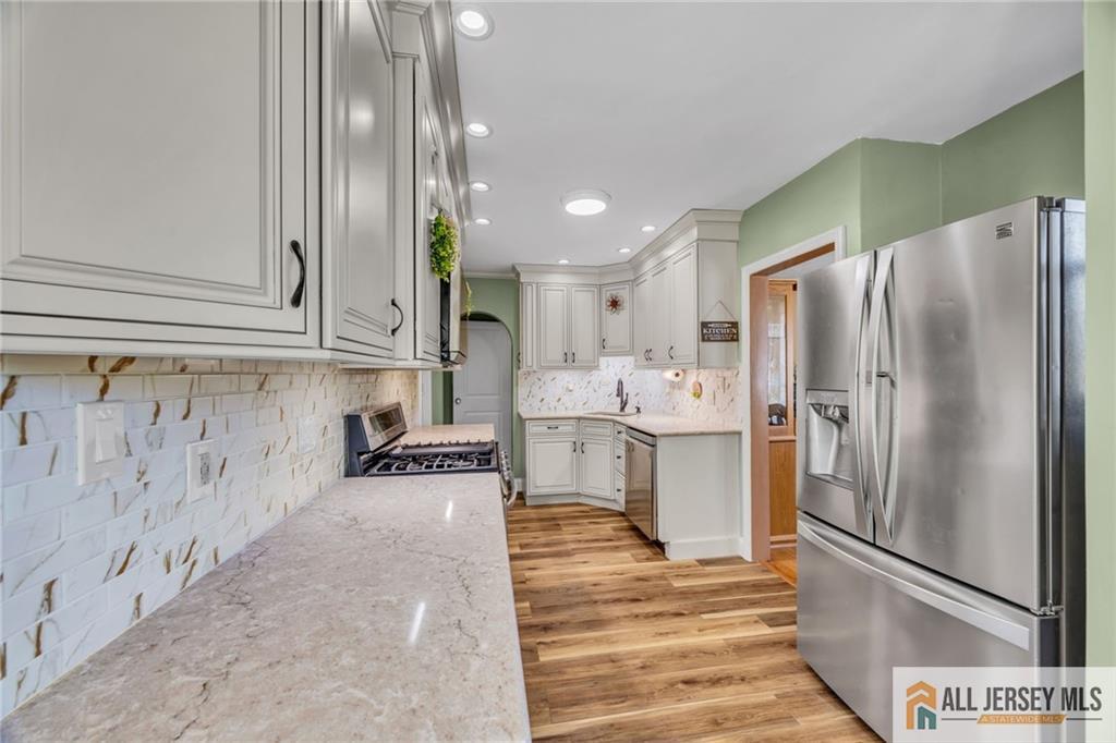 38 Simpson Avenue Edison, NJ 08817 - Photo 9 of 37 a kitchen with stainless steel appliances refrigerator oven and cabinets