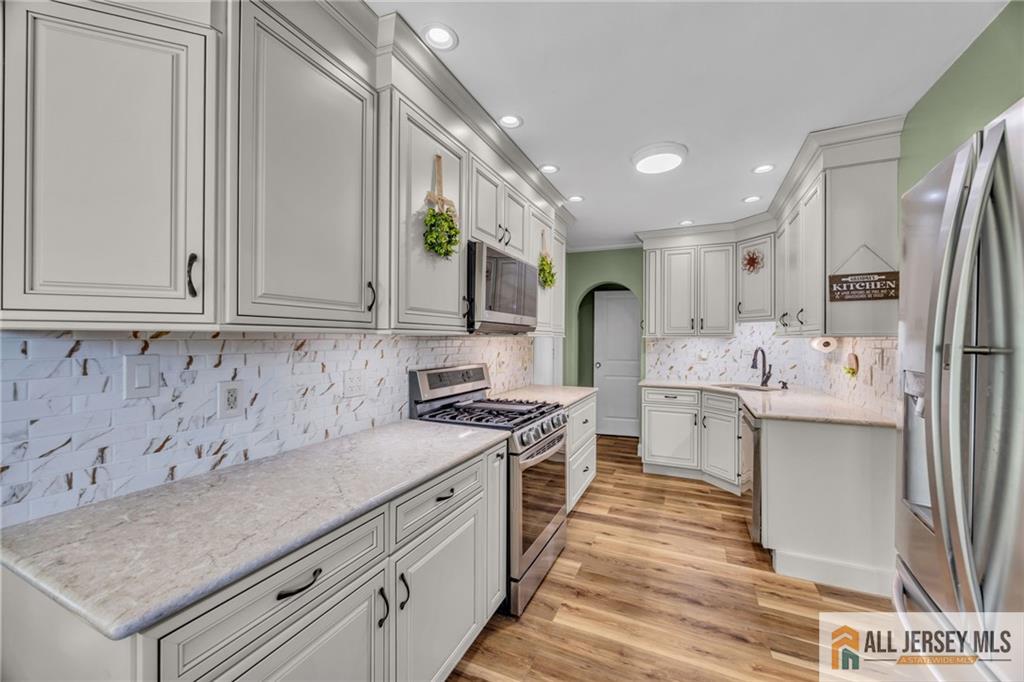 38 Simpson Avenue Edison, NJ 08817 - Photo 10 of 37 a kitchen with a sink stove and cabinets