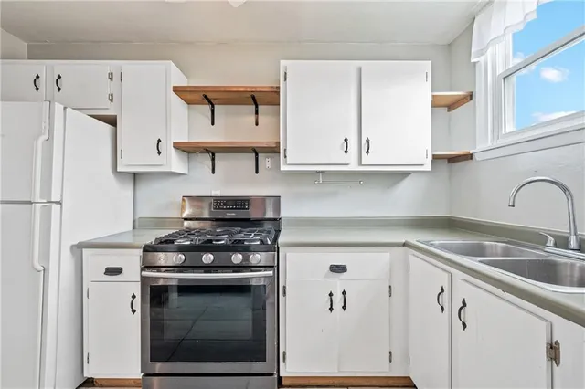 a kitchen with stainless steel appliances granite countertop a stove and a refrigerator