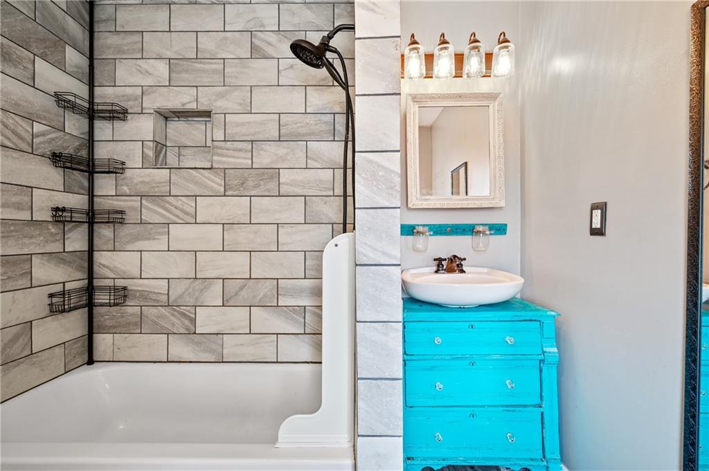 840 7th Street Verona, PA 15147 - Photo 21 of 32 a bathroom with a bathtub sink and mirror