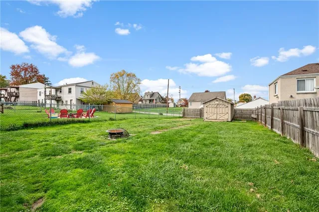 a group of cars parked in front of house with yard