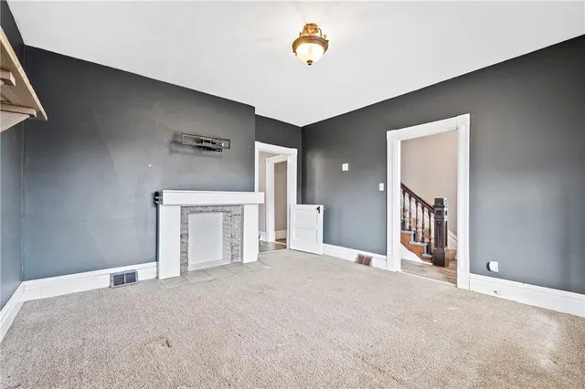 a view of a hallway with wooden floor and a livingroom view