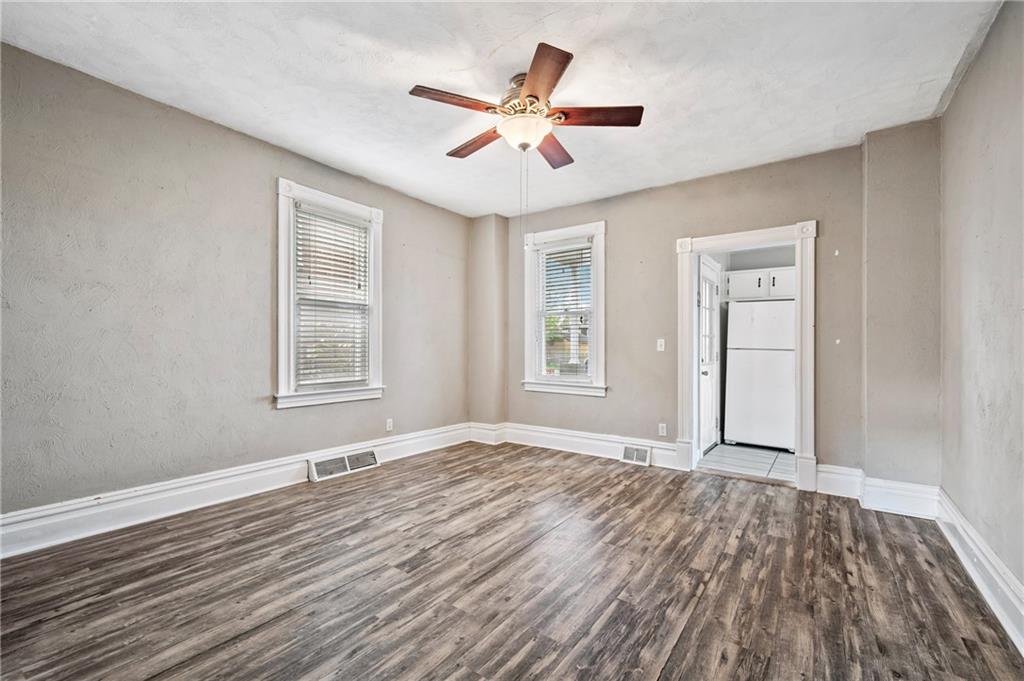 840 7th Street Verona, PA 15147 - Photo 10 of 32 a view of an empty room with wooden floor and a window